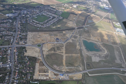 Aerial photograph of Clay Farm from the south, including Shelford Road, Addenbrooke's Road and the spine road and lake. Countryside/Tamdown, 19 March 2012.